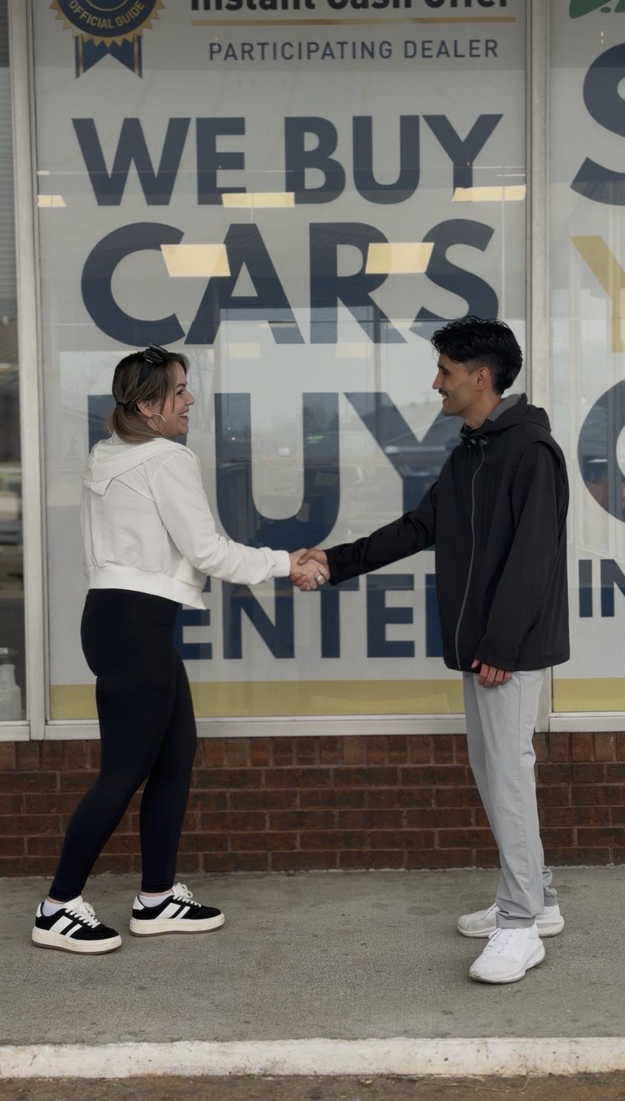 A Lakeway buyer shaking hands with a seller outside the Buy Center